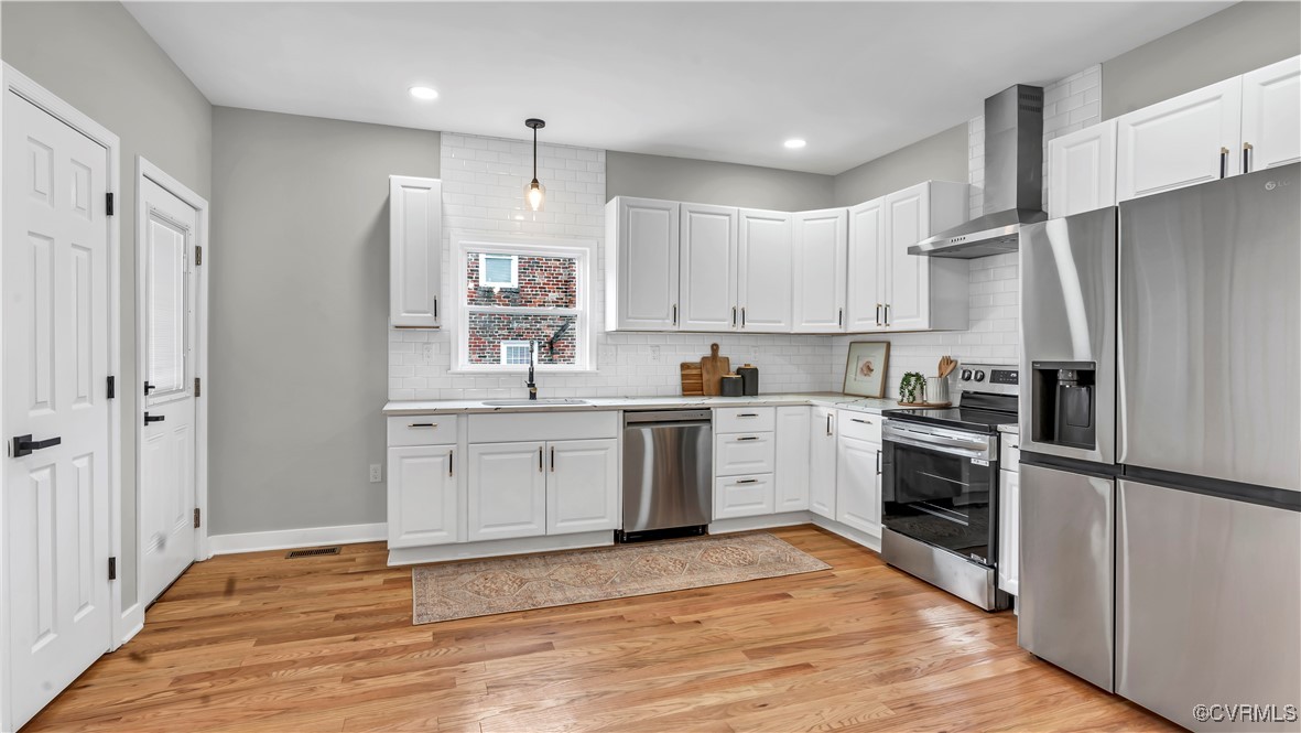 1320 Decatur Street Richmond, VA 23224 - Photo 8 of 36 a kitchen with a refrigerator stove and wooden floor