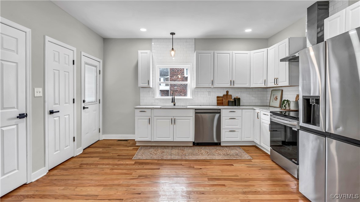 1320 Decatur Street Richmond, VA 23224 - Photo 9 of 36 a kitchen with stainless steel appliances granite countertop a refrigerator sink and white cabinets