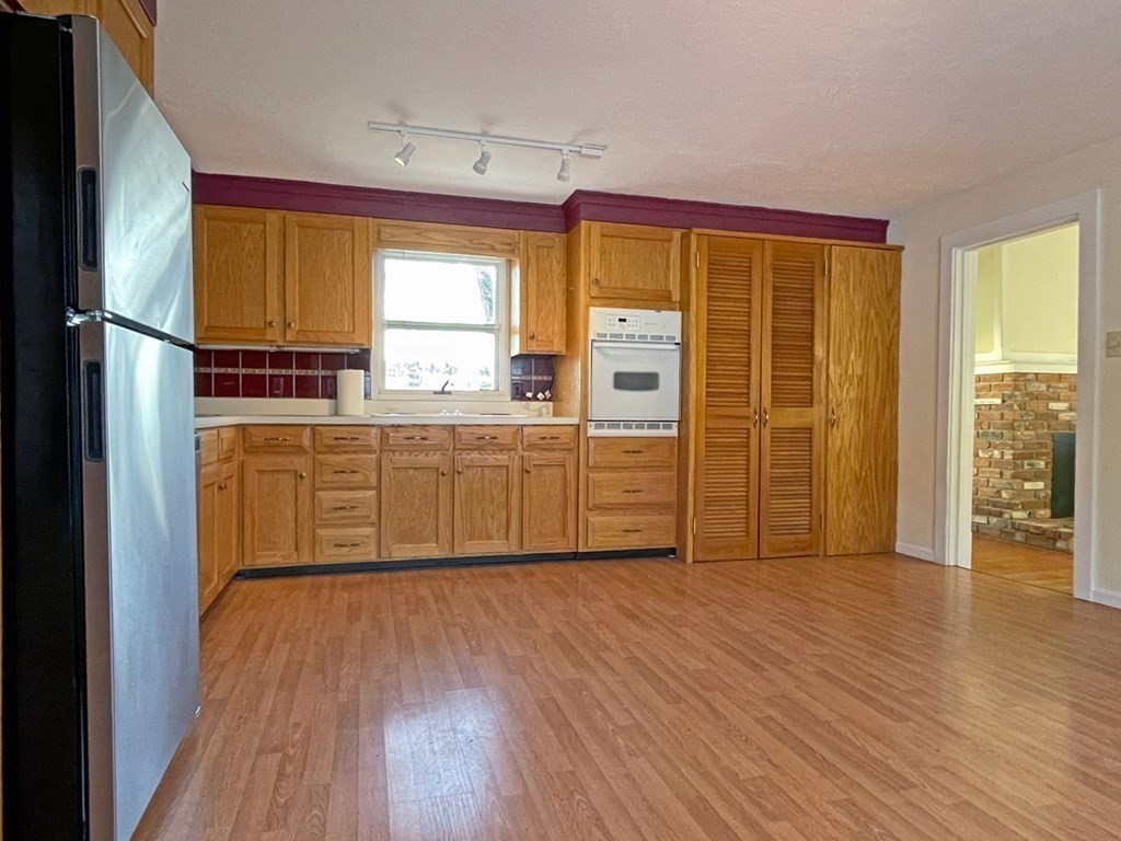 53 Burrows Turnpike Road Bernardston, MA 01337 - Photo 15 of 42 a room with kitchen island granite countertop wooden floors and wide window