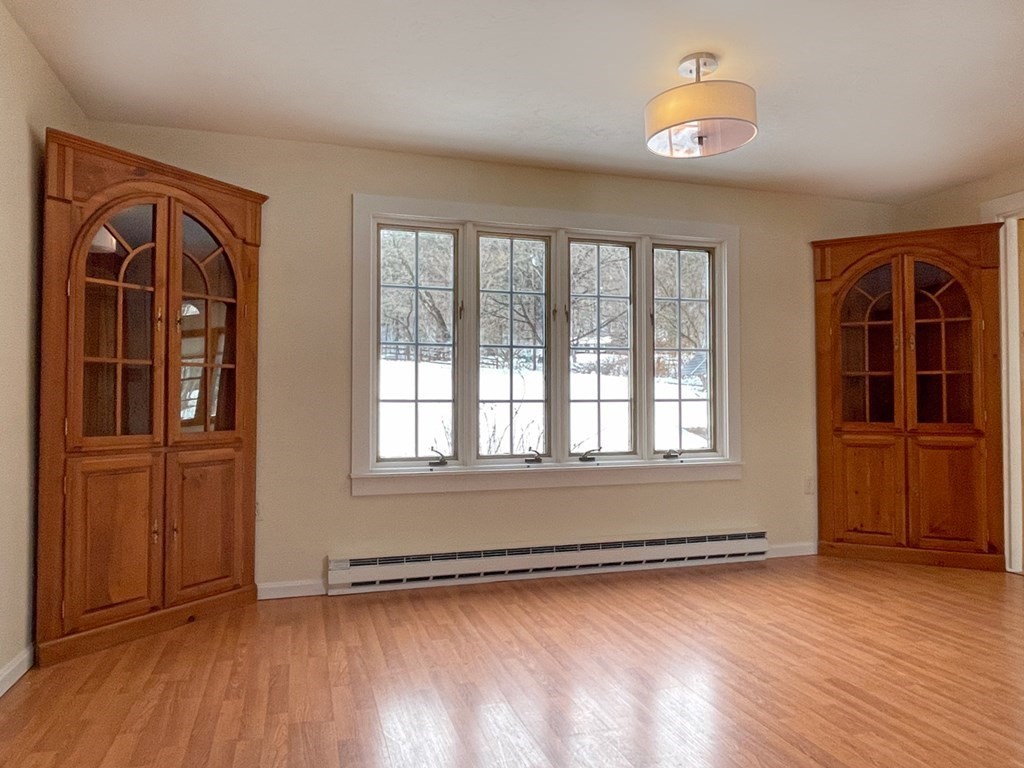 53 Burrows Turnpike Road Bernardston, MA 01337 - Photo 19 of 42 an empty room with wooden floor and windows