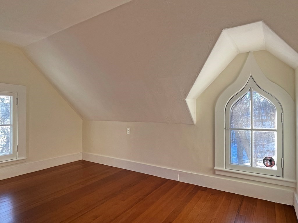 53 Burrows Turnpike Road Bernardston, MA 01337 - Photo 36 of 42 an empty room with wooden floor and windows