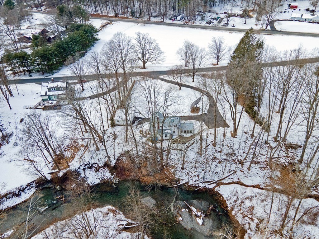 53 Burrows Turnpike Road Bernardston, MA 01337 - Photo 41 of 42 a view of a lake with a yard and wooden fence