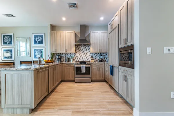 a kitchen with stainless steel appliances sink refrigerator and microwave
