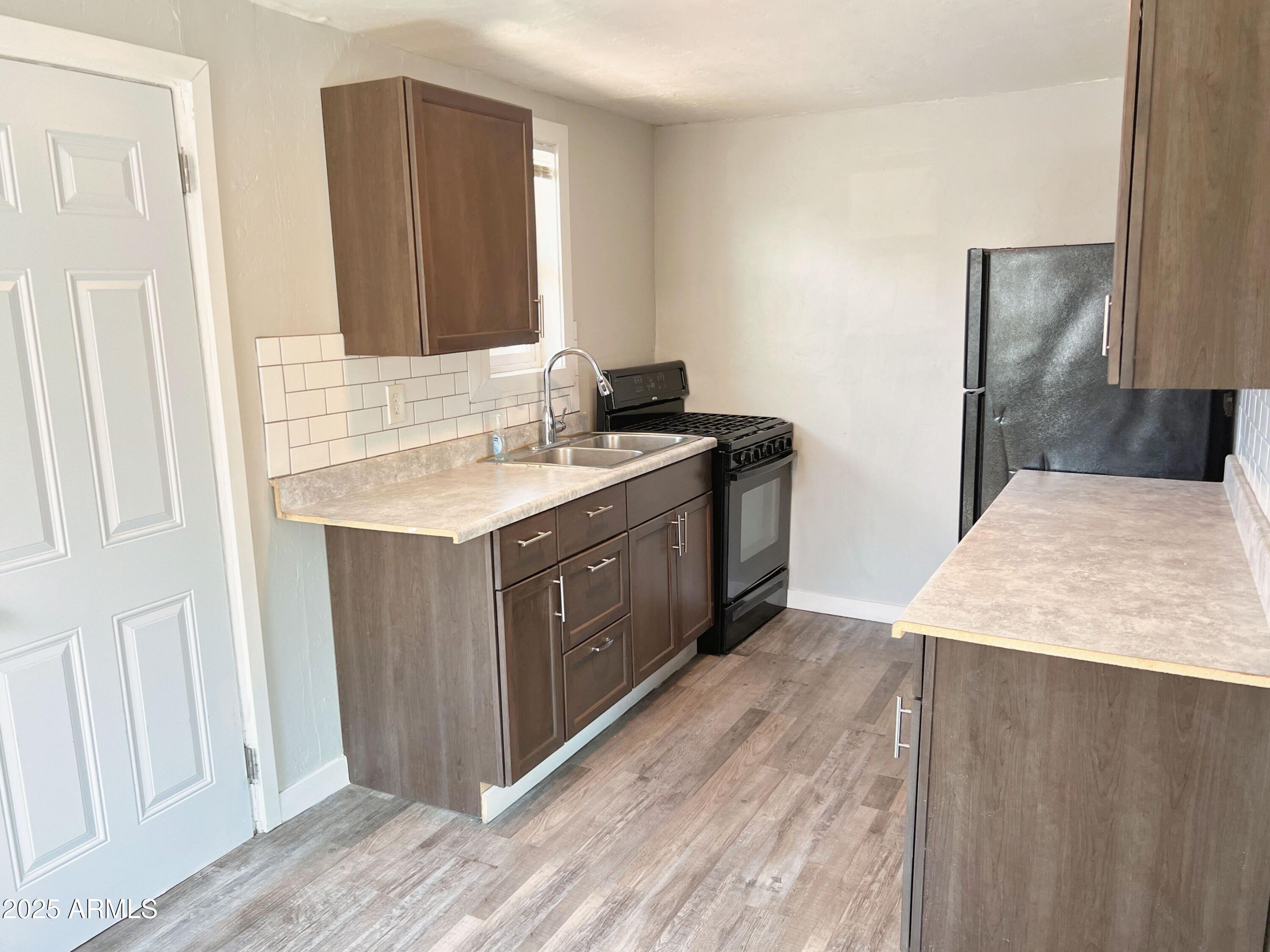 1125 East Devonshire Avenue, Unit 2 Phoenix, AZ 85014 - Photo 2 of 8 a kitchen with a stove and a sink