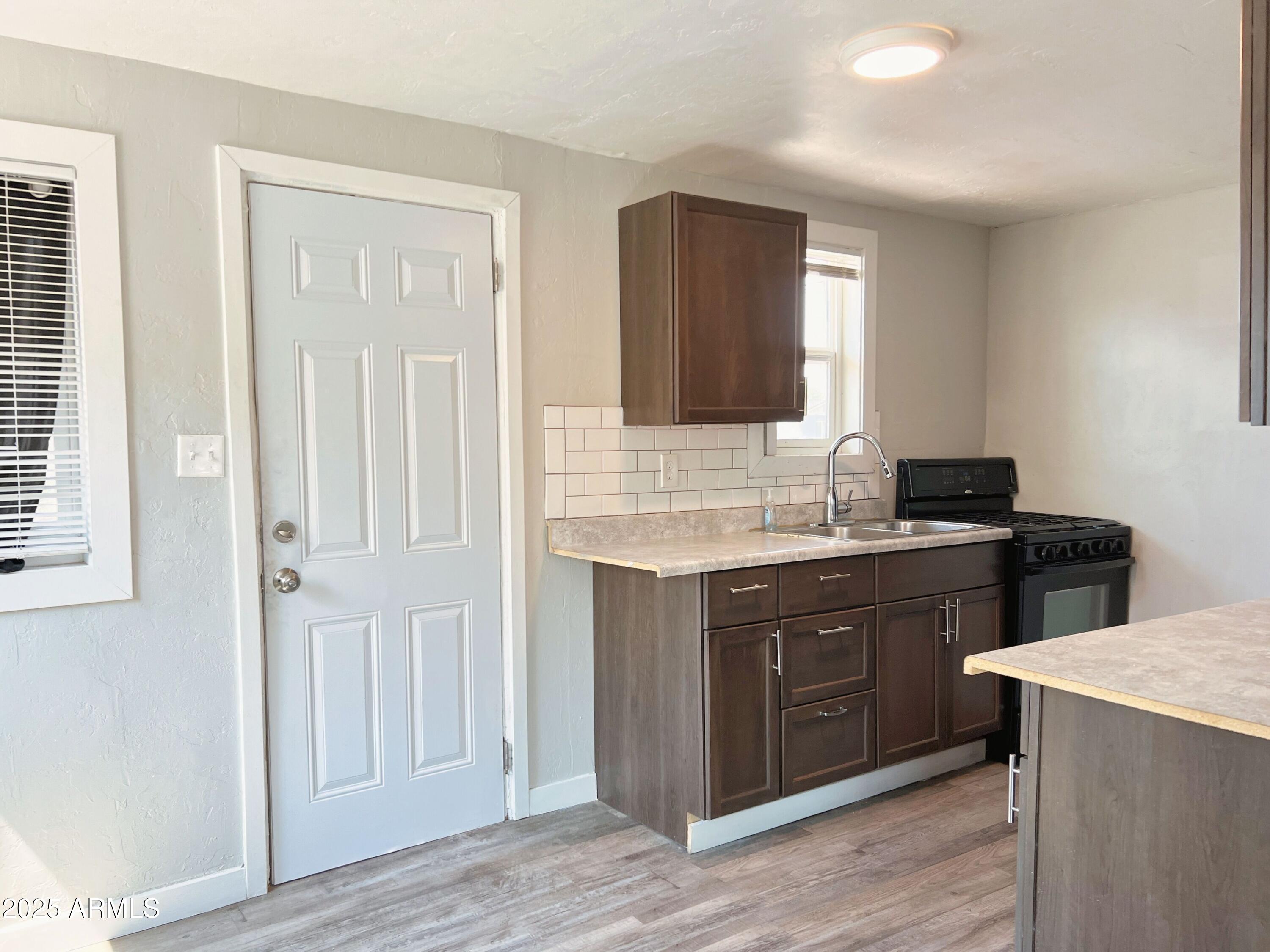1125 East Devonshire Avenue, Unit 2 Phoenix, AZ 85014 - Photo 3 of 8 a sink with a vanity and a mirror