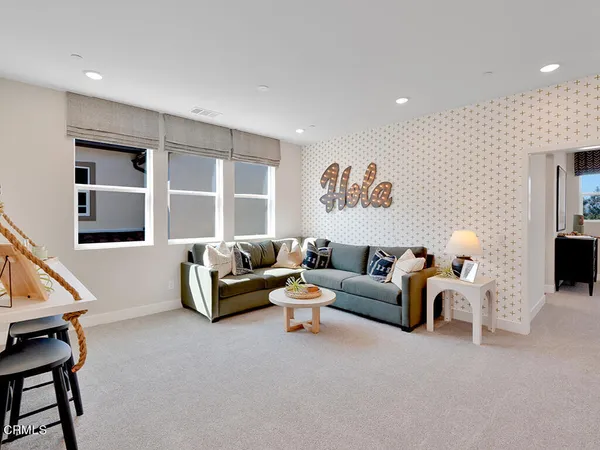 a living room with furniture and a potted plant