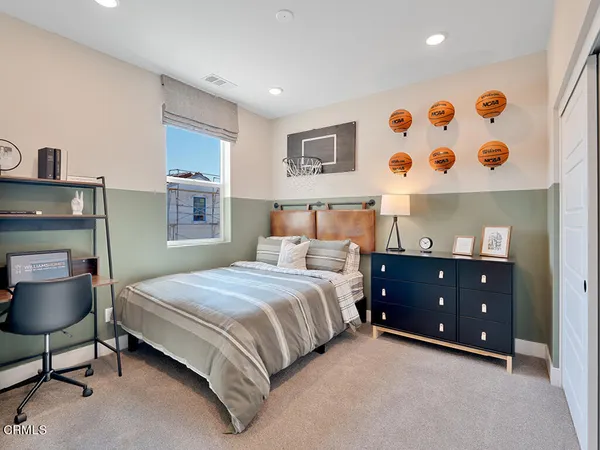a bedroom with a bed and a night stand