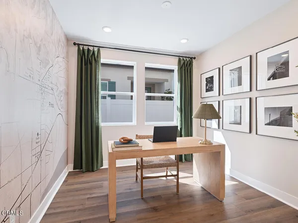 a workspace with wooden floor and furniture