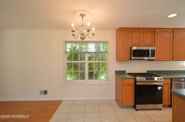 a kitchen with stainless steel appliances granite countertop a sink and a microwave
