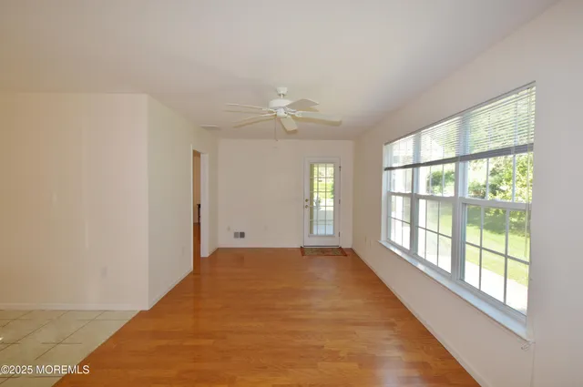 an empty room with windows and closet
