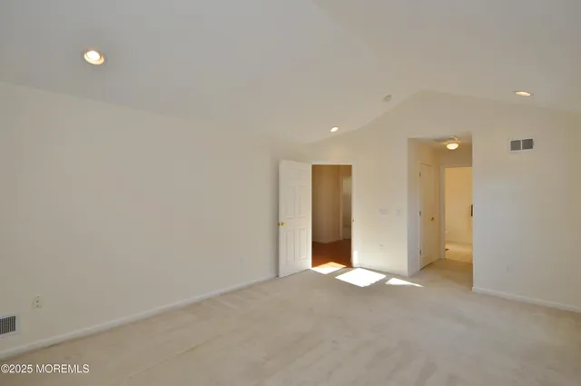 a spacious bathroom with a double vanity sink mirror and toilet