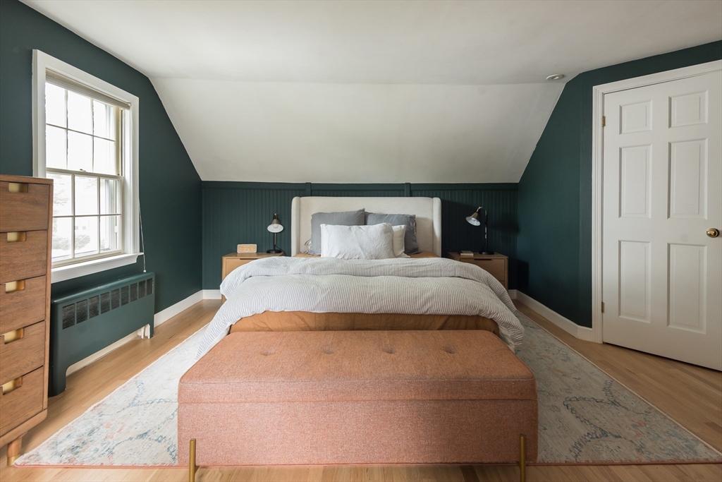 7 Robinson Road Woburn, MA 01801 - Photo 14 of 21 a bedroom with a large bed and wooden floor