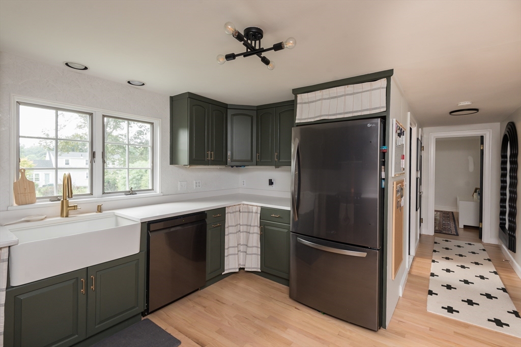 7 Robinson Road Woburn, MA 01801 - Photo 4 of 21 a kitchen with stainless steel appliances a refrigerator sink and cabinets