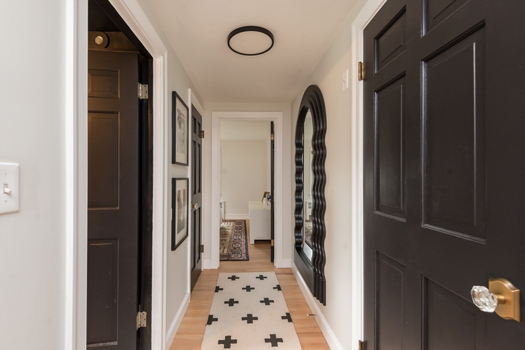 7 Robinson Road Woburn, MA 01801 - Photo 7 of 21 a view of a hallway with windows and furniture