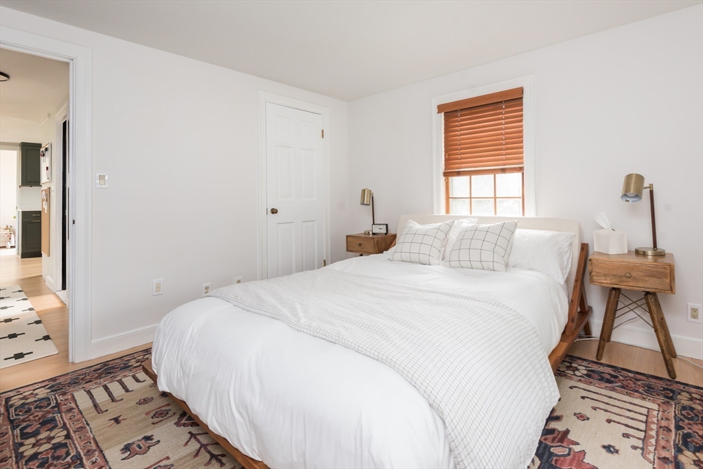 7 Robinson Road Woburn, MA 01801 - Photo 10 of 21 a bedroom with a bed and wooden floor