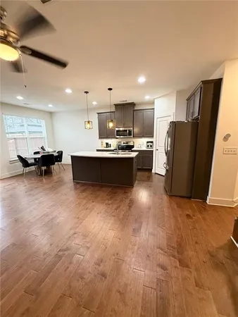 a view of kitchen with stainless steel appliances granite countertop lots of counter top space