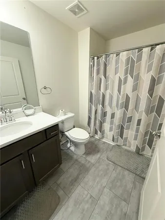 a spacious bathroom with a double vanity sink toilet and a shower