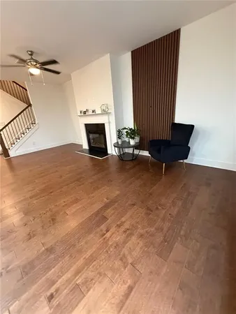 an empty room with windows and fireplace