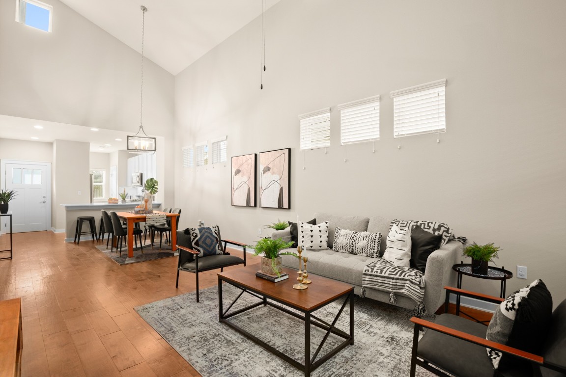 8945 Parker Ranch Circle, Unit B Austin, TX 78748 - Photo 1 of 1 Living room featuring high vaulted ceiling, light wood-type flooring, and a chandelier