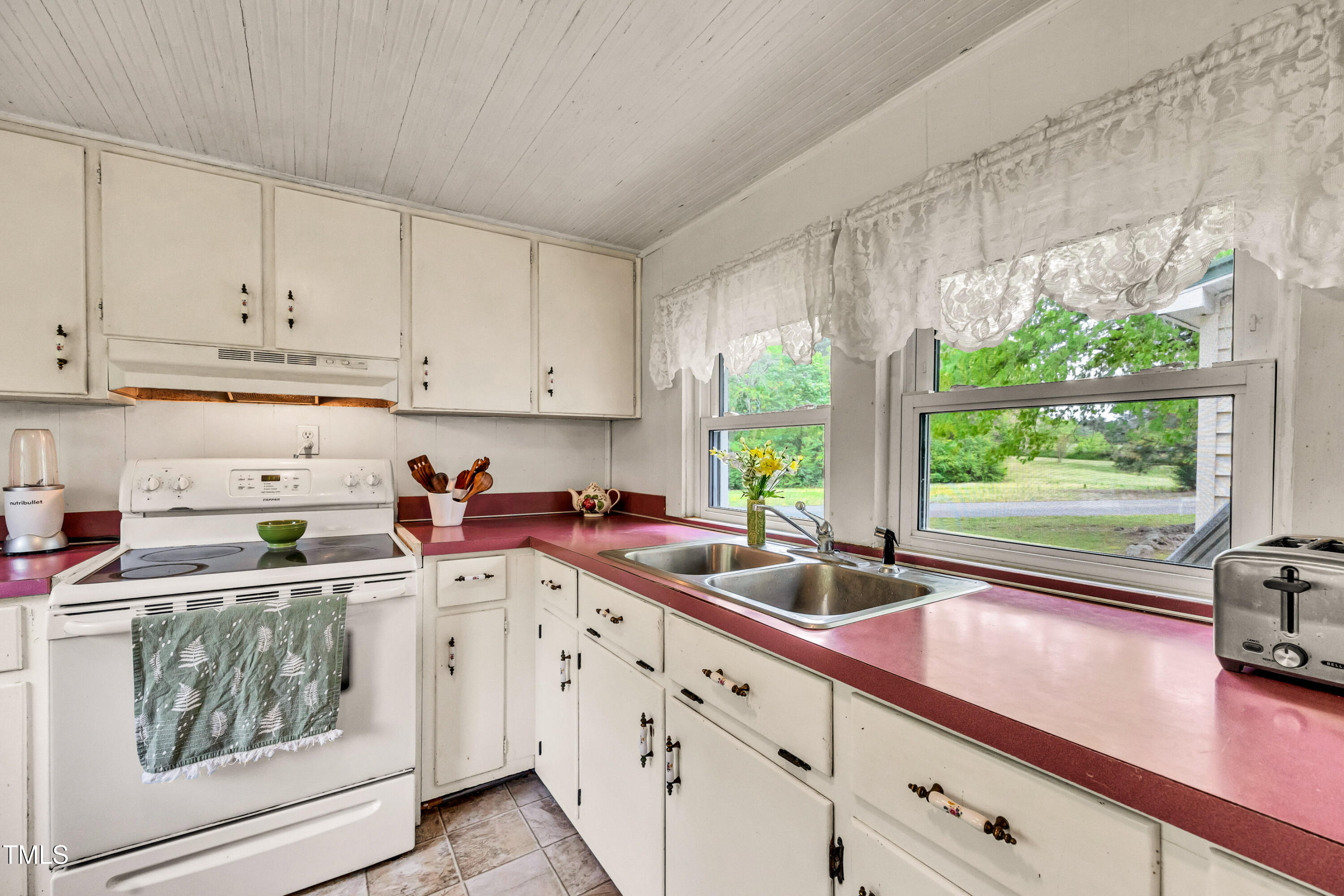 489 Purvis Farm Road Robbins, NC 27325 - Photo 13 of 32 a kitchen with stainless steel appliances white cabinets a sink and a window