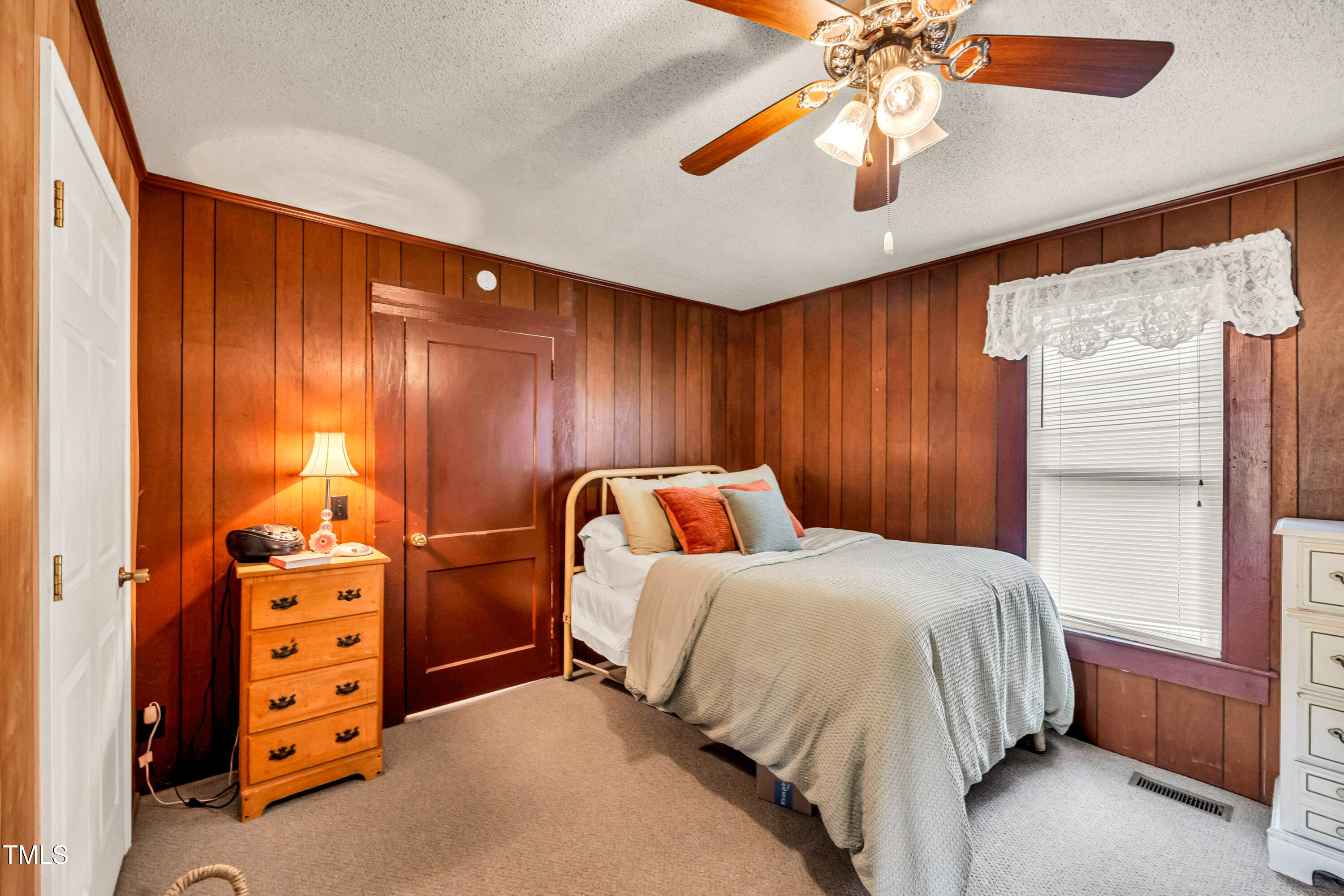 489 Purvis Farm Road Robbins, NC 27325 - Photo 17 of 32 a bedroom with a bed and a chandelier