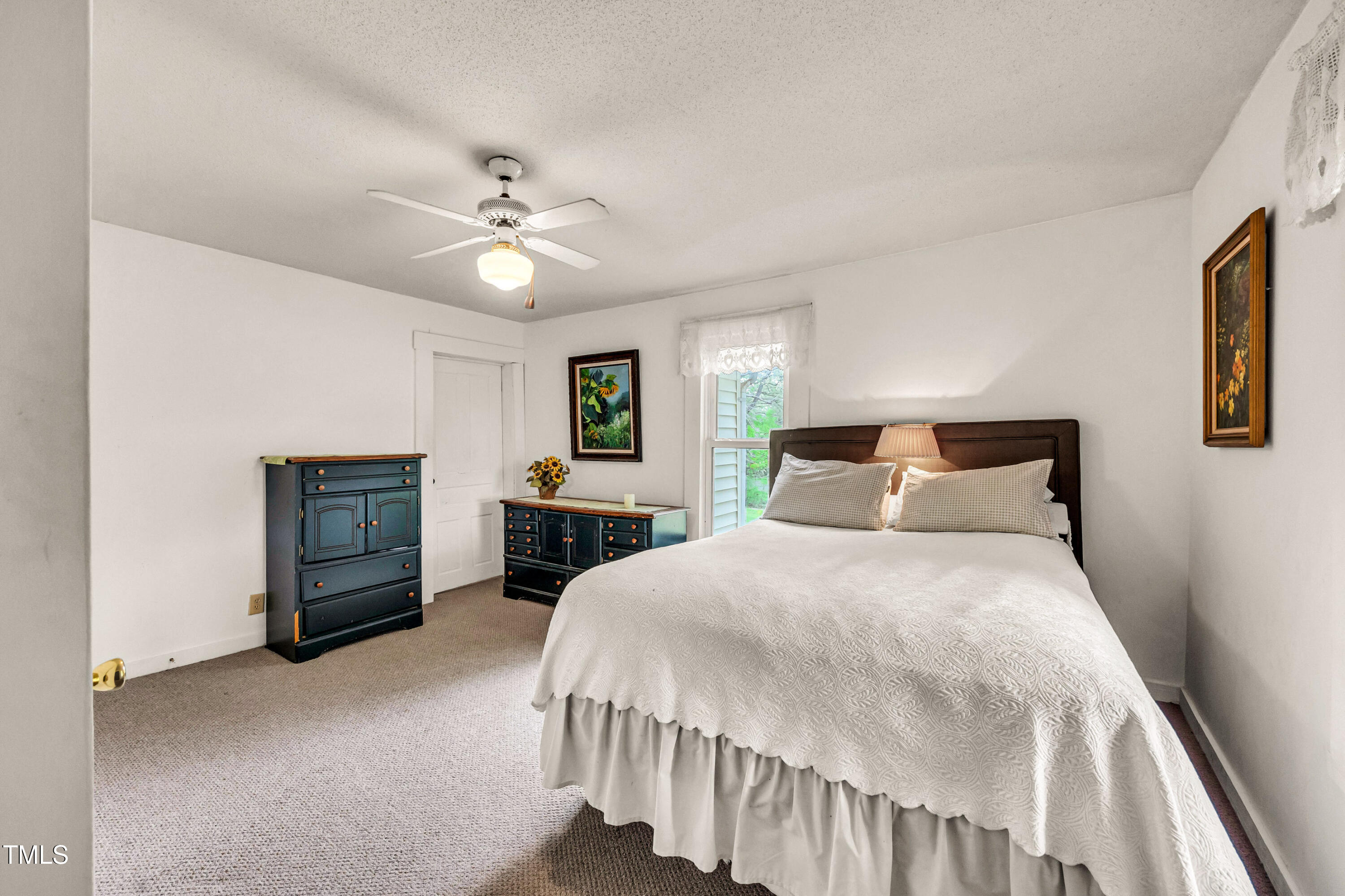 489 Purvis Farm Road Robbins, NC 27325 - Photo 21 of 32 a bedroom with a bed and a chandelier