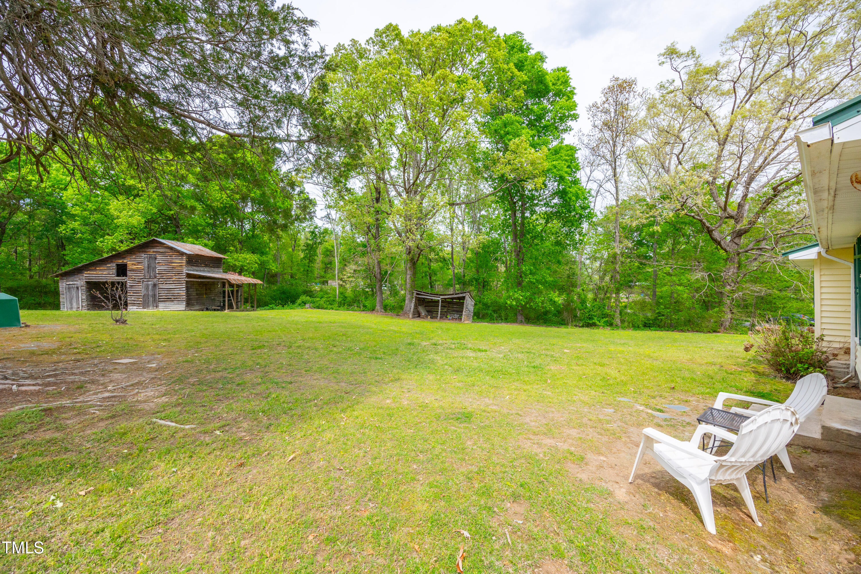 489 Purvis Farm Road Robbins, NC 27325 - Photo 25 of 32 a yellow house with swimming pool in front of it