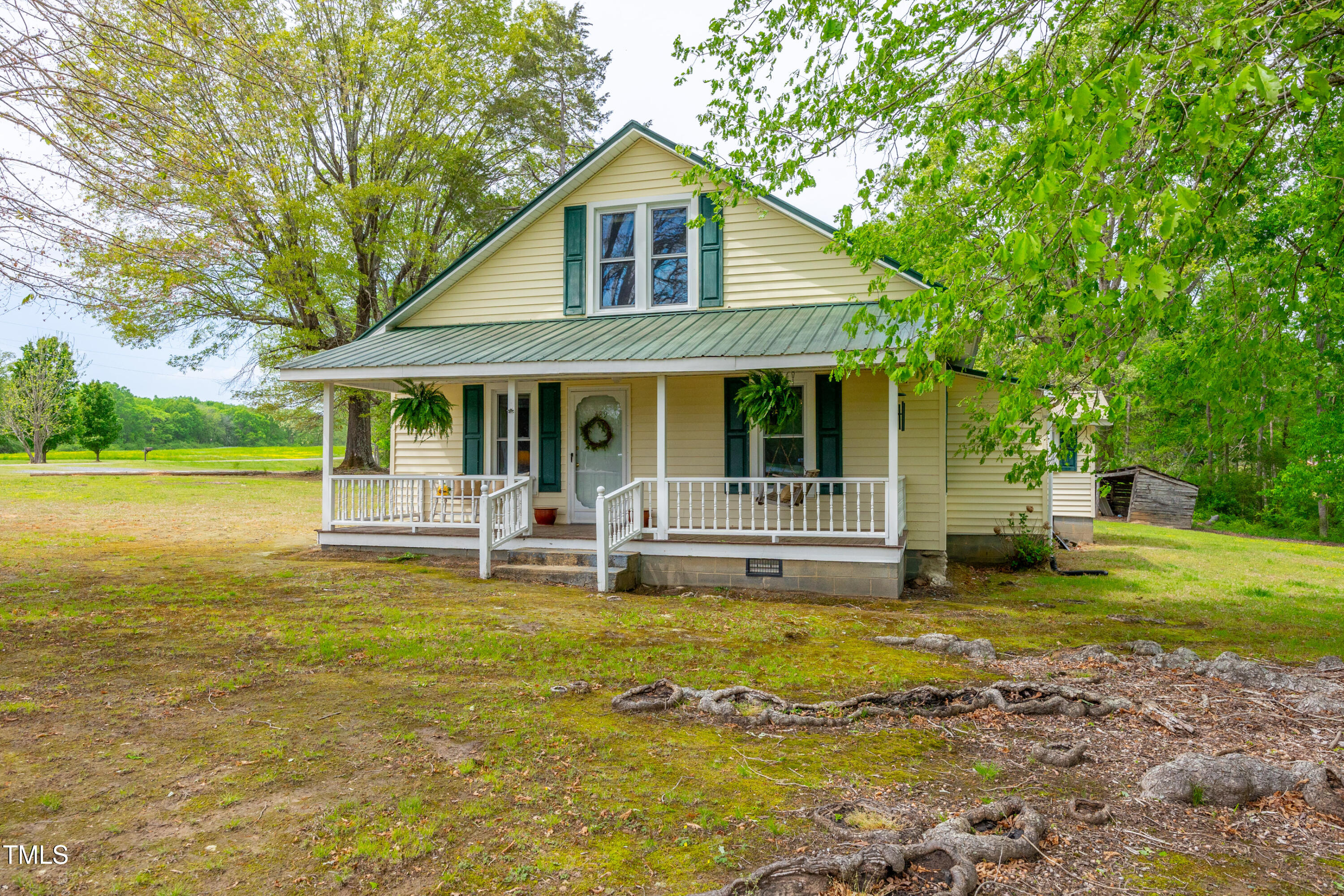 489 Purvis Farm Road Robbins, NC 27325 - Photo 3 of 32 a front view of a house with swimming pool and yard