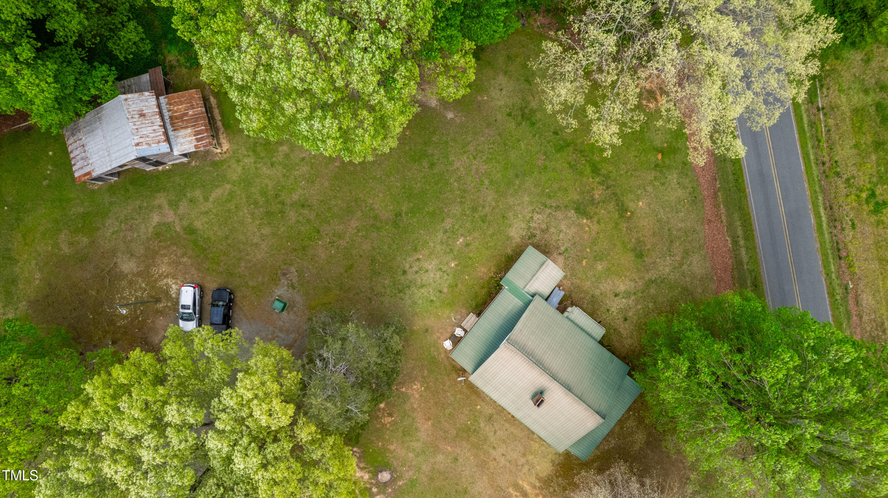489 Purvis Farm Road Robbins, NC 27325 - Photo 31 of 32 an aerial view of a house with swimming pool and large trees