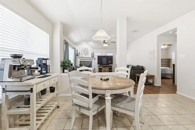 a large kitchen with a table and chairs