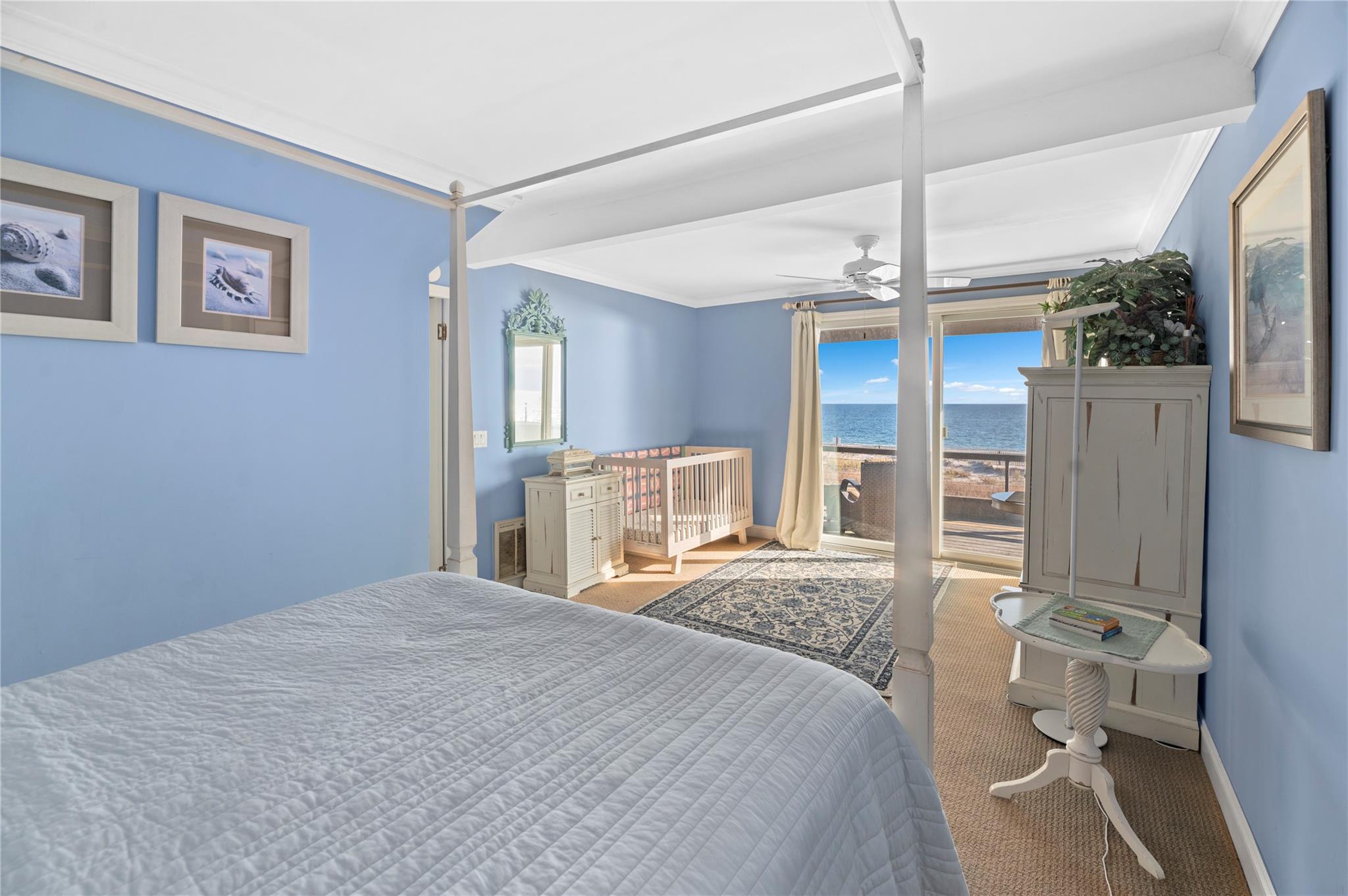 400 Ocean View Walk Ocean Beach, NY 11770 - Photo 14 of 21 a bedroom with a large bed and a chandelier