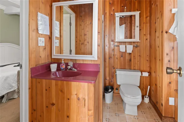 a bathroom with a granite countertop sink mirror vanity and toilet