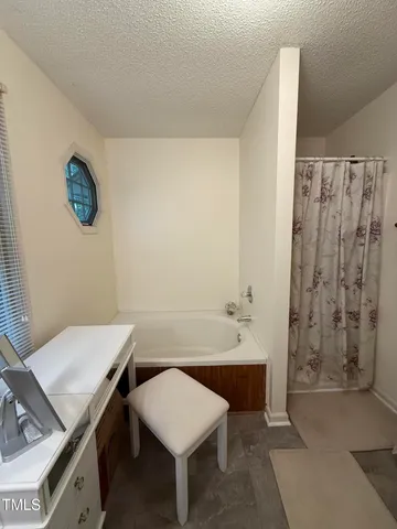 a spacious bathroom with a double vanity sink a mirror and a bathtub