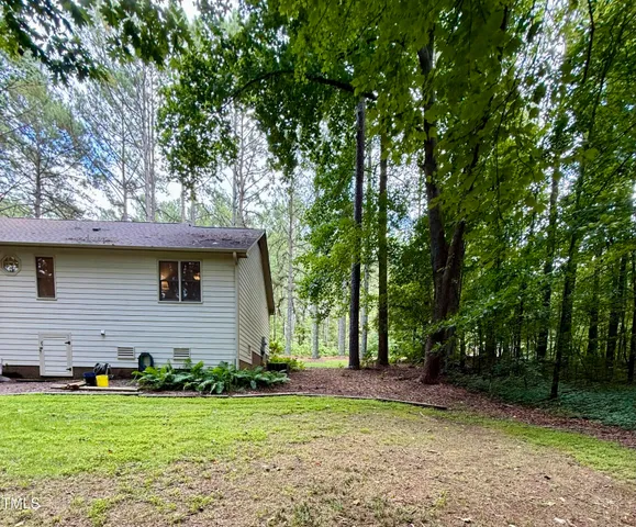 a front view of house with a garden