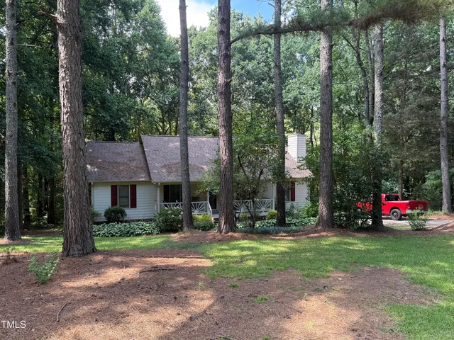 a front view of a house with a yard table and chairs