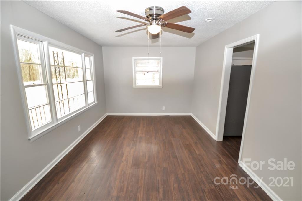 2433 State Rd S-46-172, Unit 3 Clover, SC 29710 - Photo 4 of 22 wooden floor in an empty room with a window