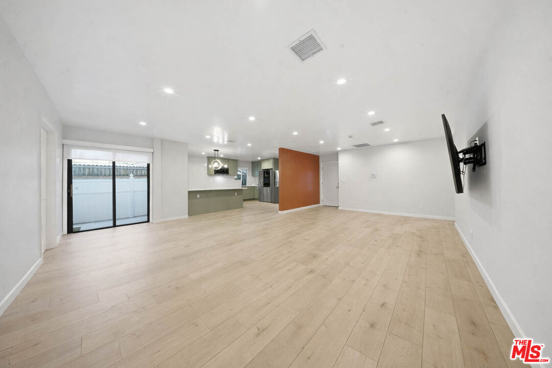 20237 Hartland Street Winnetka, CA 91306 - Photo 3 of 13 a view of a kitchen with a refrigerator and a sink