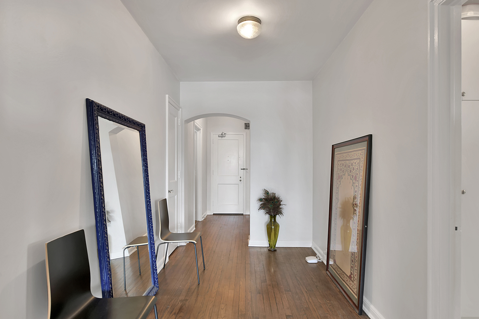 5555 North Sheridan Road, Unit 507 Chicago, IL 60640 - Photo 2 of 15 a view of a hallway with wooden floor and furniture