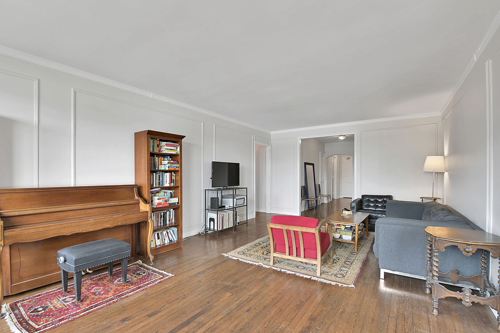 5555 North Sheridan Road, Unit 507 Chicago, IL 60640 - Photo 3 of 15 a living room with furniture and wooden floor