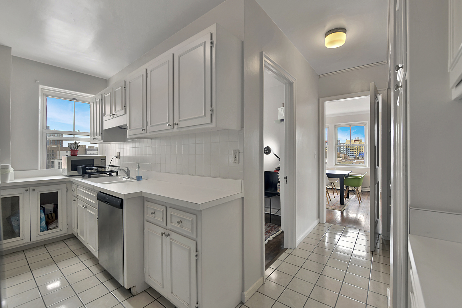 5555 North Sheridan Road, Unit 507 Chicago, IL 60640 - Photo 7 of 15 a kitchen with cabinets and white appliances