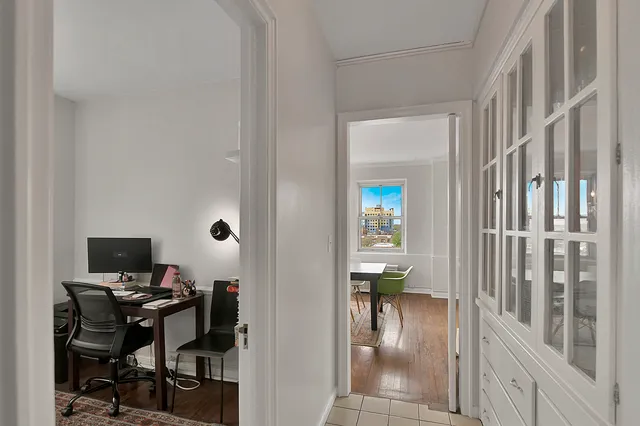 a spacious bedroom with a bed and a chandelier