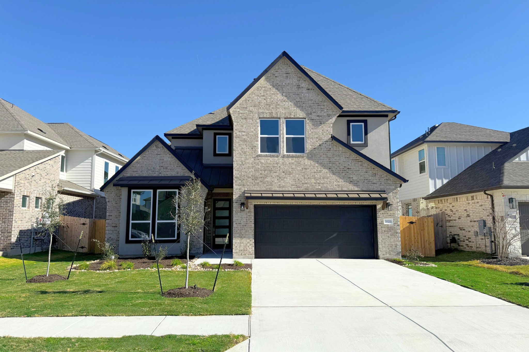 20233 Dustin Lane Pflugerville, TX 78660 - Photo 1 of 1 a front view of a house with a yard