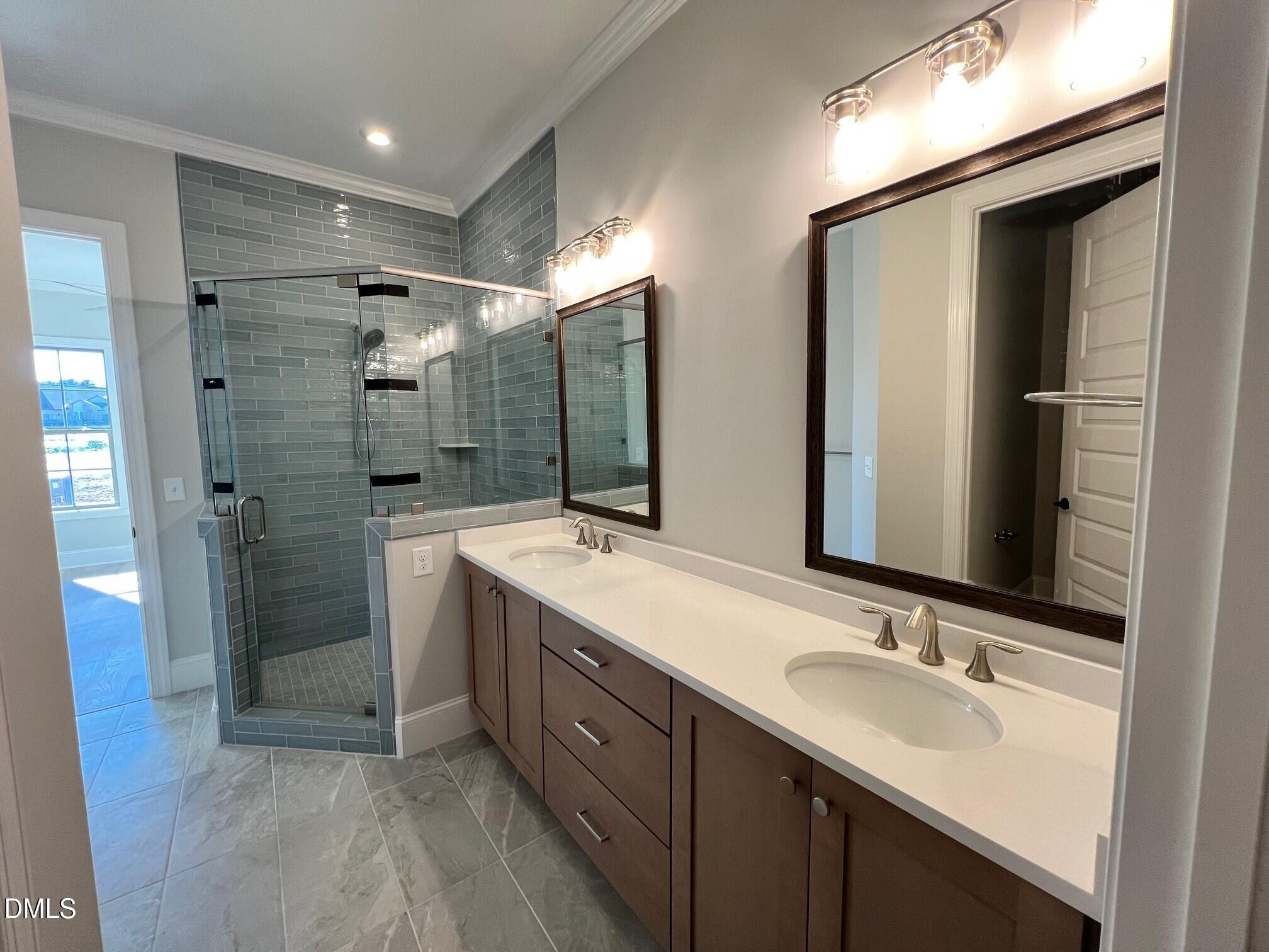 1003 Coldspring Circle Durham, NC 27705 - Photo 11 of 24 a bathroom with a double vanity sink mirror and shower