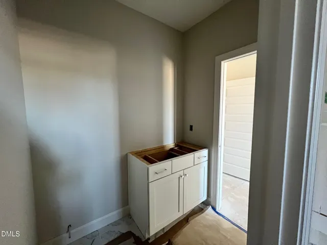 a kitchen with a dining table chairs stainless steel appliances and cabinets