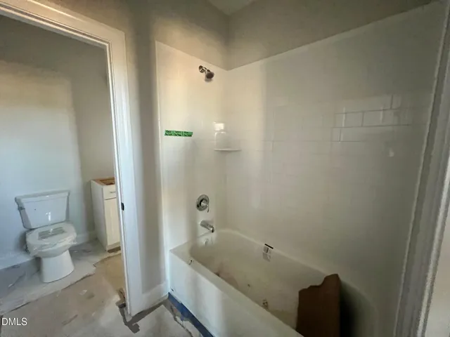 a kitchen with a dining table chairs stainless steel appliances and cabinets