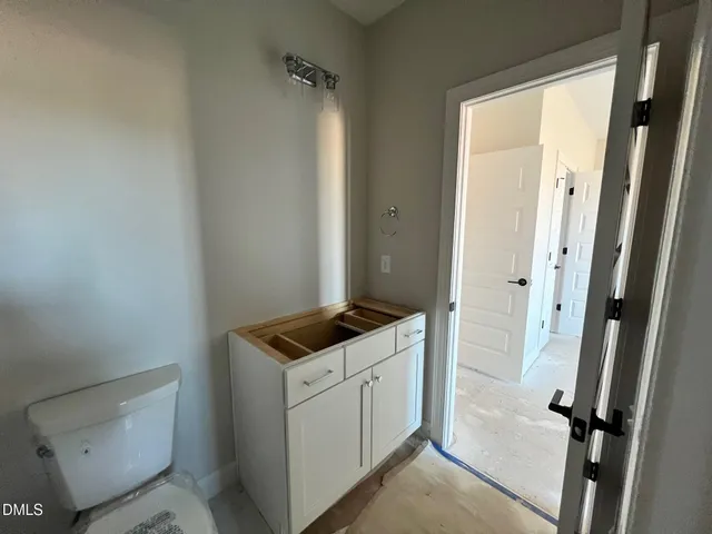 a kitchen with kitchen island a white table and chairs in it