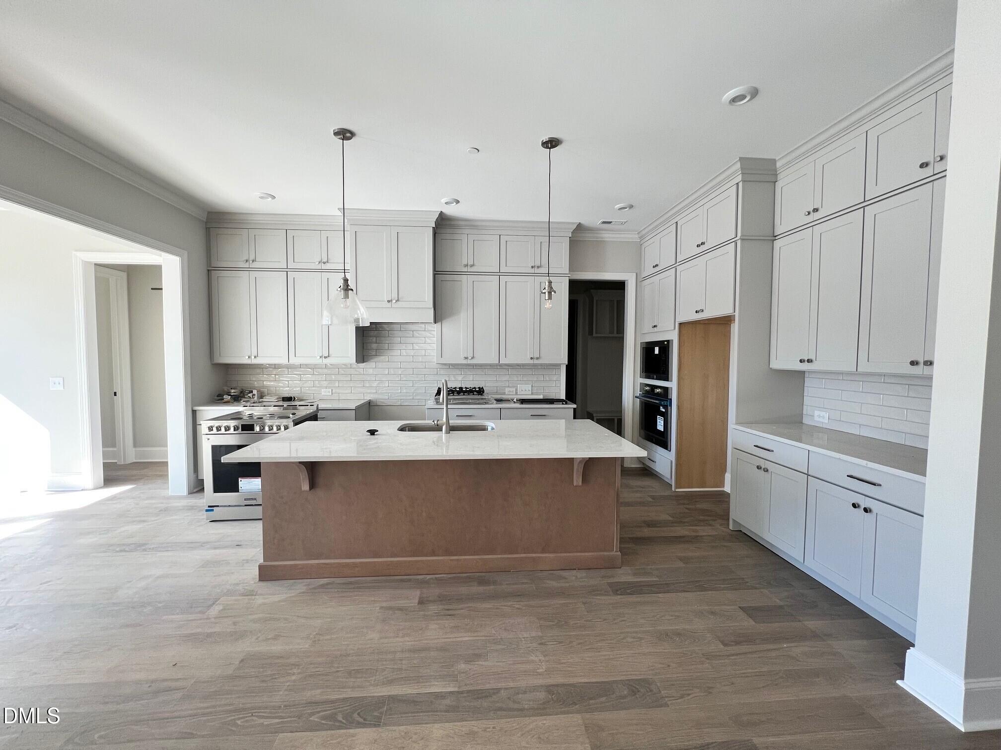 1003 Coldspring Circle Durham, NC 27705 - Photo 6 of 24 a view of kitchen with stainless steel appliances granite countertop a stove and a refrigerator