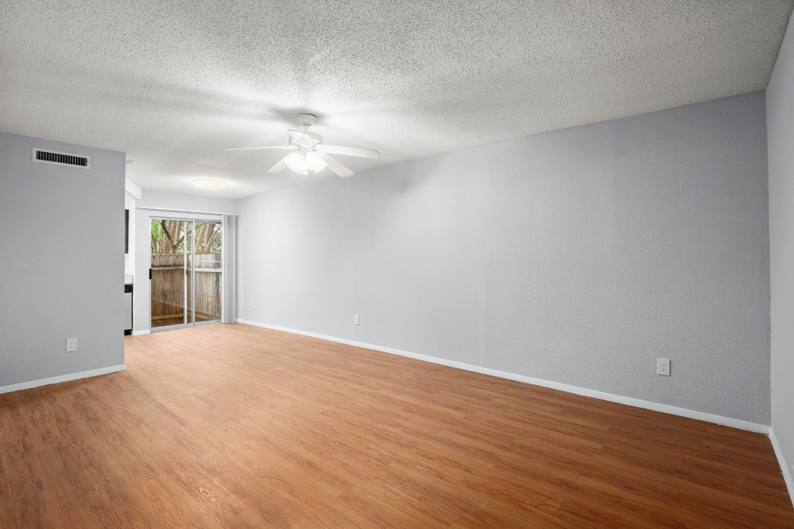 3415 Menchaca Road, Unit 101 Austin, TX 78704 - Photo 11 of 14 a view of an empty room with window and wooden floor