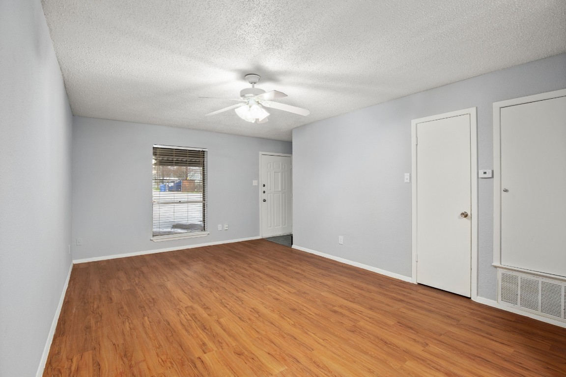 3415 Menchaca Road, Unit 101 Austin, TX 78704 - Photo 12 of 14 wooden floor in an empty room with a window