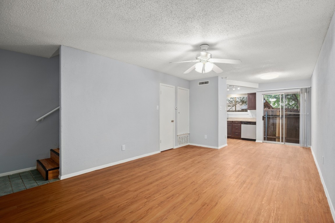 3415 Menchaca Road, Unit 101 Austin, TX 78704 - Photo 3 of 14 a view of a big room with wooden floor chandelier fan and windows